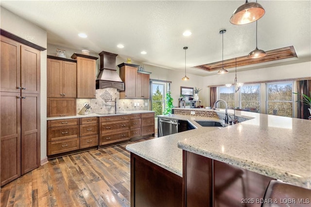 kitchen featuring premium range hood, a sink, stainless steel dishwasher, dark wood-type flooring, and black electric cooktop