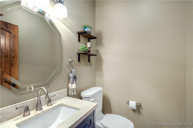half bathroom featuring toilet and vanity
