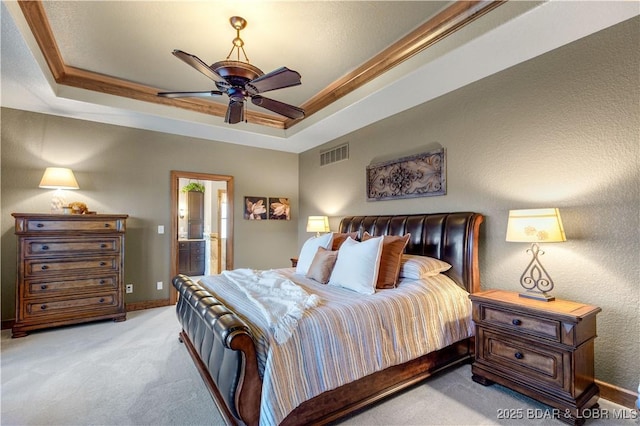 bedroom with light carpet, a raised ceiling, baseboards, crown molding, and ceiling fan