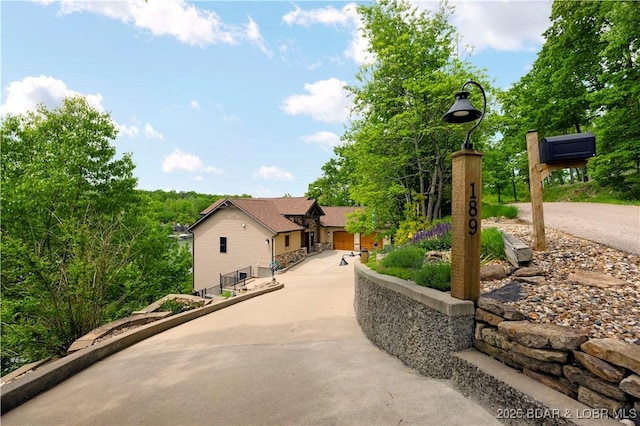 view of property's community with concrete driveway