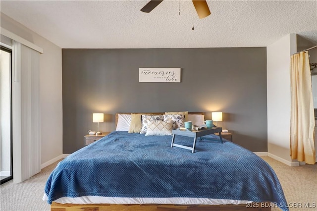 carpeted bedroom with a ceiling fan, baseboards, and a textured ceiling