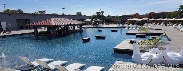 community pool featuring a gazebo and a water slide