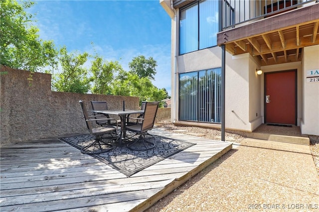wooden deck featuring outdoor dining area