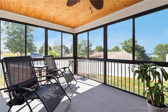 sunroom with a healthy amount of sunlight and ceiling fan