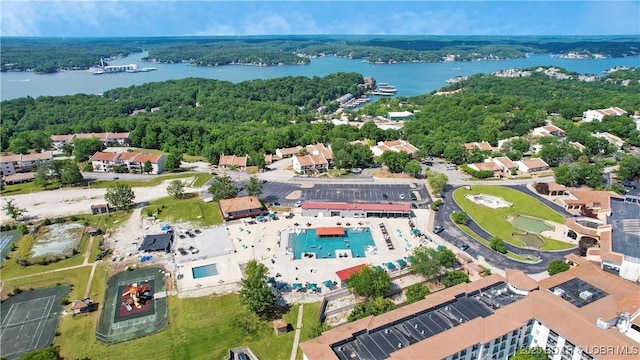 bird's eye view with a water view and a view of trees