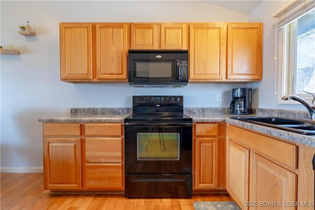 1522 Cherokee Rd Unit 2B, Lake Ozark, MO 65049 - kitchen with black appliances, a sink, light wood-style floors, vaulted ceiling, and light brown cabinetry