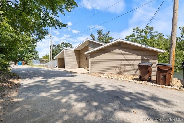 view of property exterior with aphalt driveway