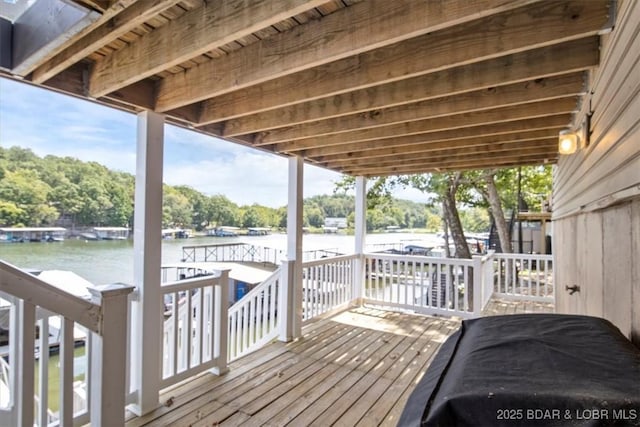 wooden deck featuring a water view