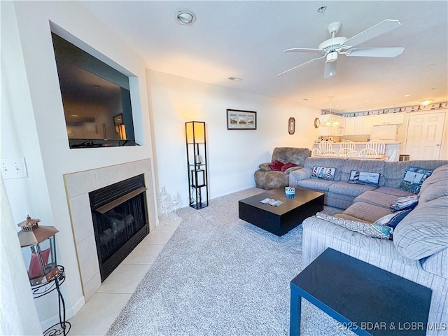 686 Clearwater Dr Unit 1E, Camdenton, MO 65020 - living room featuring ceiling fan, light colored carpet, and a tile fireplace