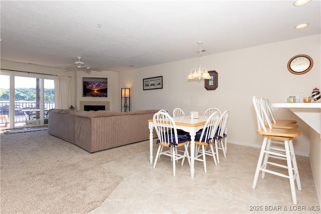 686 Clearwater Dr Unit 1E, Camdenton, MO 65020 - dining area featuring a ceiling fan, a chandelier, a fireplace, baseboards, and recessed lighting