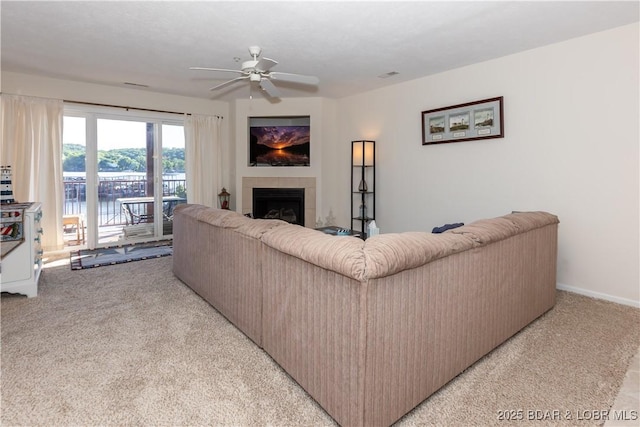 686 Clearwater Dr Unit 1E, Camdenton, MO 65020 - living area with light carpet, ceiling fan, a fireplace, and a water view