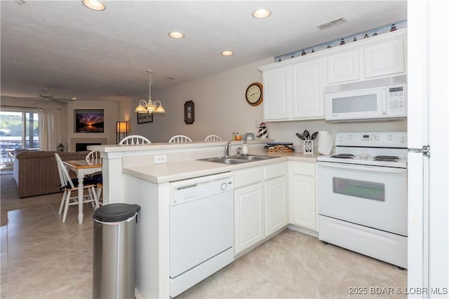 686 Clearwater Dr Unit 1E, Camdenton, MO 65020 - kitchen with white appliances, a peninsula, open floor plan, a sink, and recessed lighting