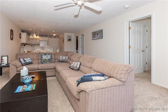 686 Clearwater Dr Unit 1E, Camdenton, MO 65020 - living room with light colored carpet, a ceiling fan, and a chandelier