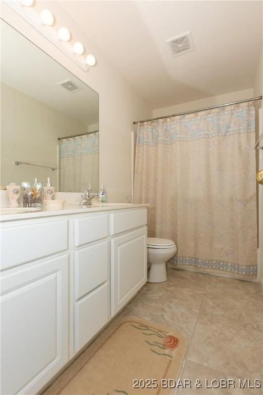 686 Clearwater Dr Unit 1E, Camdenton, MO 65020 - bathroom with vanity, toilet, and tile patterned flooring