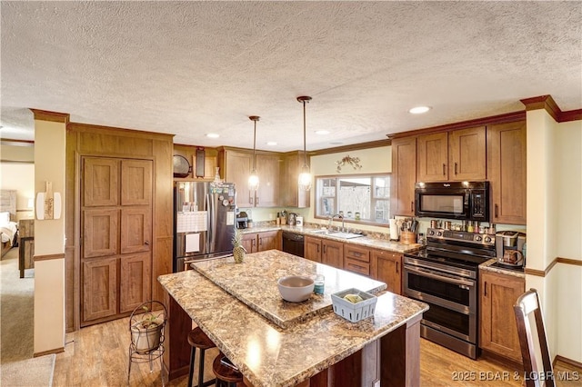 kitchen with crown molding, brown cabinets, and black appliances