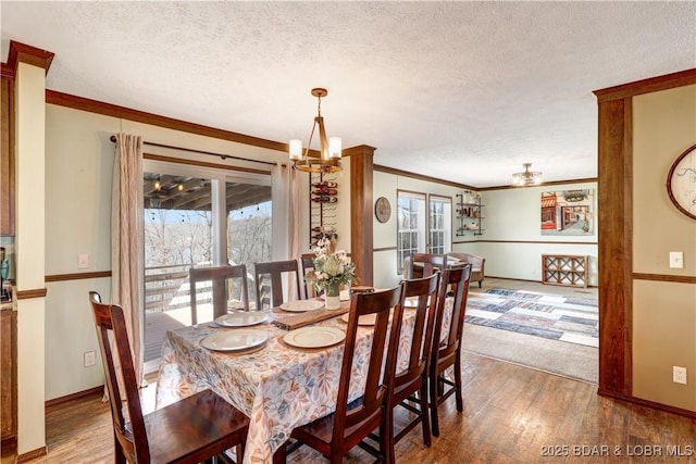 dining area featuring crown molding, a textured ceiling, plenty of natural light, and wood finished floors