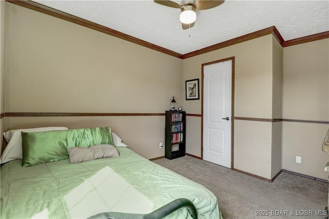carpeted bedroom with crown molding, baseboards, and ceiling fan