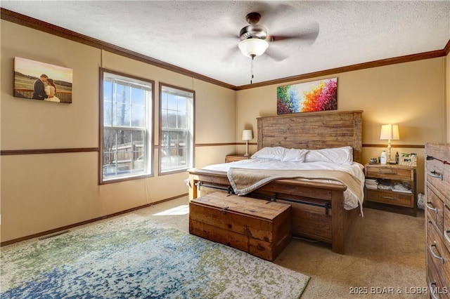 bedroom with carpet floors, a ceiling fan, a textured ceiling, and ornamental molding
