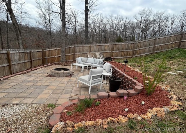 view of patio / terrace featuring a fenced backyard and an outdoor living space with a fire pit