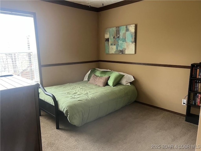 bedroom featuring carpet flooring and baseboards
