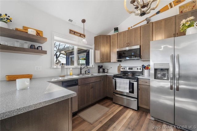 27570 Golden Point Ln, Barnett, MO 65011 - kitchen featuring appliances with stainless steel finishes, lofted ceiling, dark wood-type flooring, hanging light fixtures, and open shelves