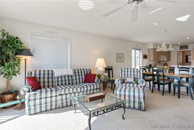 262 Bluff Blvd Unit 1B, Camdenton, MO 65020 - living area with ceiling fan with notable chandelier and light colored carpet