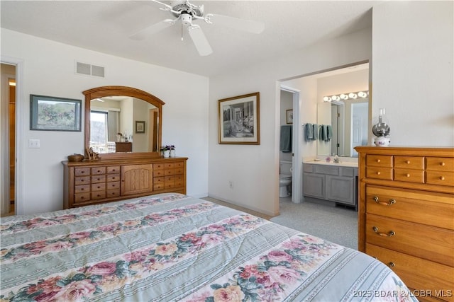 262 Bluff Blvd Unit 1B, Camdenton, MO 65020 - bedroom with visible vents, baseboards, a ceiling fan, light carpet, and ensuite bath