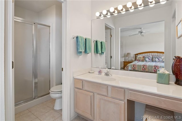 262 Bluff Blvd Unit 1B, Camdenton, MO 65020 - ensuite bathroom featuring toilet, tile patterned floors, a stall shower, ceiling fan, and ensuite bathroom