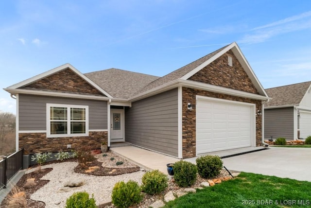 craftsman-style house featuring stone siding, concrete driveway, a shingled roof, and an attached garage