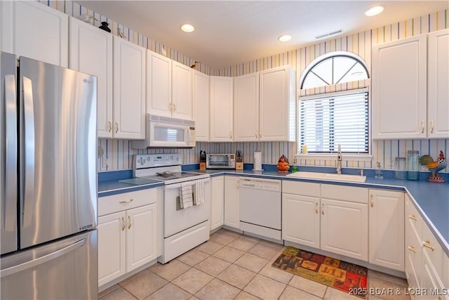 611 Lazy Days Rd Unit L6, Osage Beach, MO 65065 - kitchen with white appliances, a sink, white cabinetry, light tile patterned floors, and recessed lighting