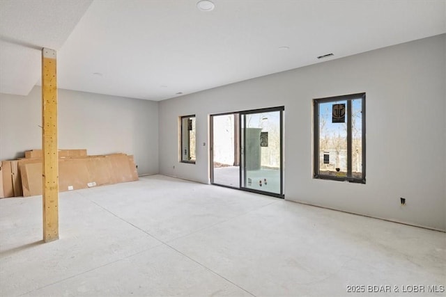 spare room featuring visible vents and concrete flooring