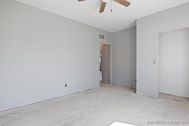 carpeted spare room with ceiling fan