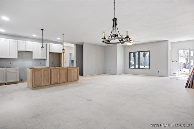 interior space featuring recessed lighting, a notable chandelier, a wealth of natural light, and pendant lighting