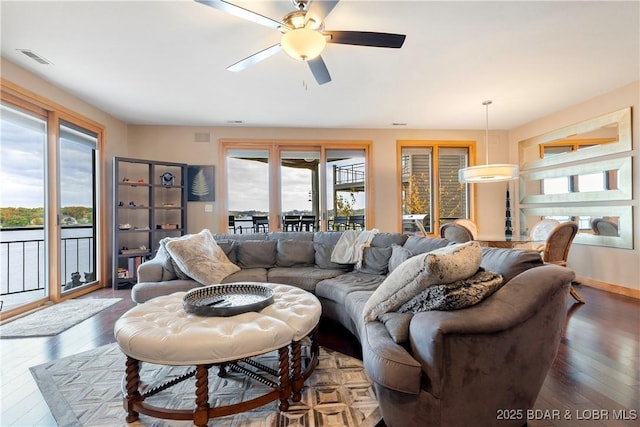 4465 Hamrock Ln Unit 502, Osage Beach, MO 65065 - living room featuring baseboards, visible vents, hardwood / wood-style flooring, and a ceiling fan