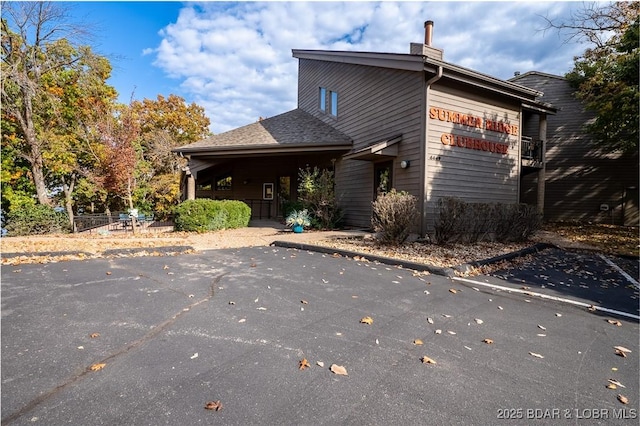 4465 Hamrock Ln Unit 502, Osage Beach, MO 65065 - back of house with a chimney
