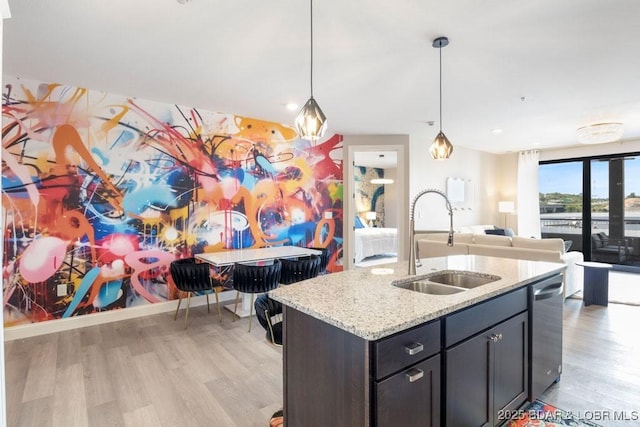 1045 Topsider Ln Unit 113, Osage Beach, MO 65065 - kitchen with a sink, light wood-style flooring, open floor plan, dishwasher, and decorative light fixtures