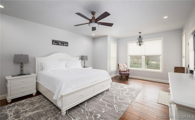 bedroom with baseboards, wood finished floors, recessed lighting, and a ceiling fan