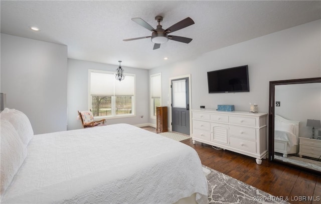 bedroom with dark wood-type flooring, a textured ceiling, recessed lighting, and a ceiling fan