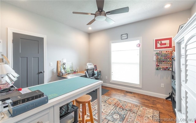 office featuring a ceiling fan, recessed lighting, baseboards, and wood finished floors