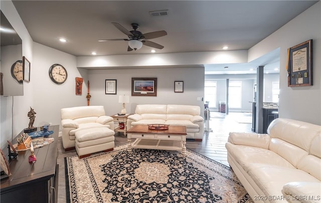 living area with visible vents, recessed lighting, a ceiling fan, and wood finished floors