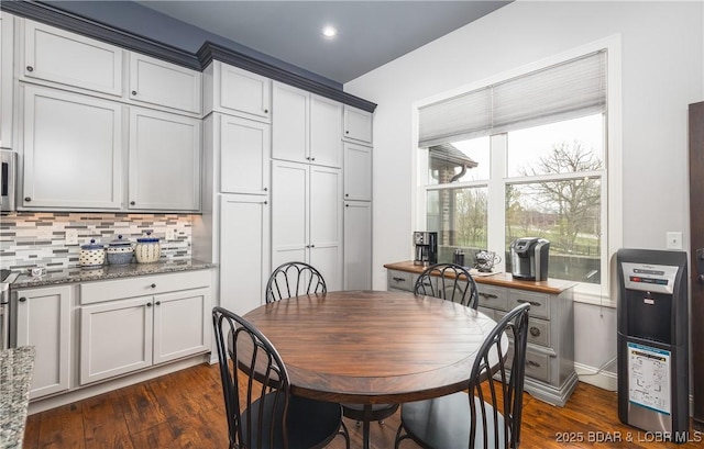 dining area featuring dark wood-type flooring