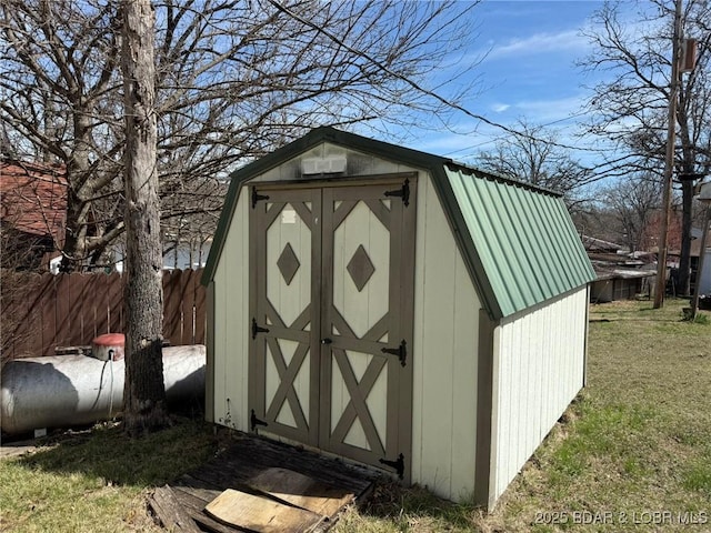 view of shed featuring fence