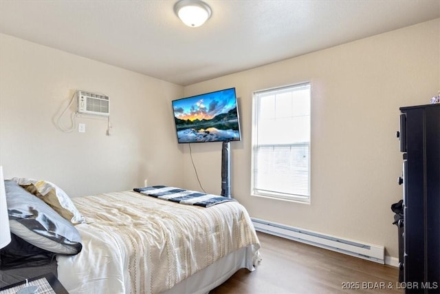 145 Oak Bnd, Kaiser, MO 65047 - bedroom with baseboard heating, wood finished floors, a wall mounted AC, and baseboards