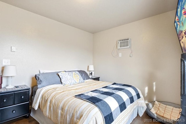 145 Oak Bnd, Kaiser, MO 65047 - bedroom with a wall unit AC and dark wood-style flooring