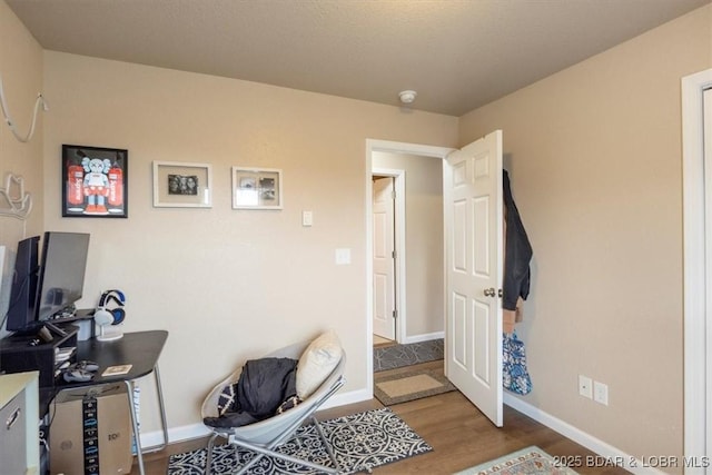 145 Oak Bnd, Kaiser, MO 65047 - living area with wood finished floors, baseboards, and a desk