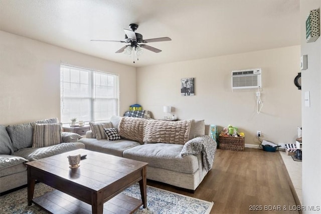145 Oak Bnd, Kaiser, MO 65047 - living room featuring a ceiling fan, wood finished floors, a wall mounted AC, and baseboards