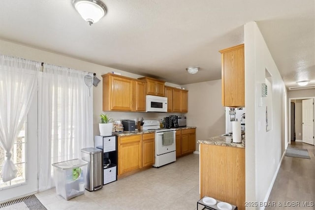 145 Oak Bnd, Kaiser, MO 65047 - kitchen with white appliances, light stone counters, and baseboards