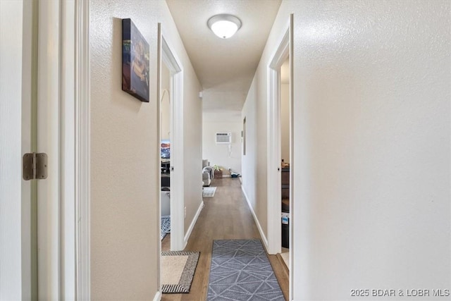 145 Oak Bnd, Kaiser, MO 65047 - corridor with wood finished floors, a wall mounted air conditioner, and baseboards