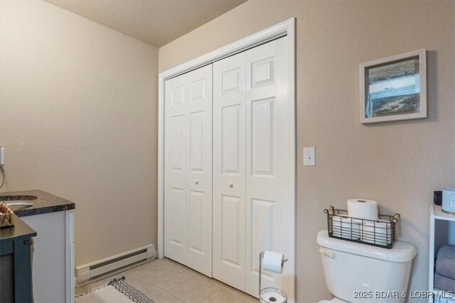 145 Oak Bnd, Kaiser, MO 65047 - bathroom featuring toilet, a baseboard radiator, vanity, tile patterned flooring, and a closet
