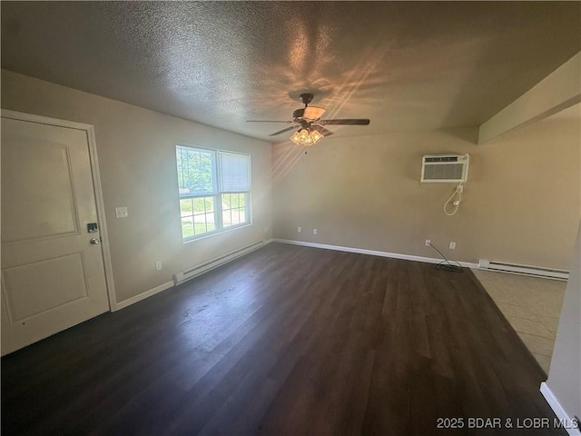 145 Oak Bnd, Kaiser, MO 65047 - unfurnished living room featuring baseboard heating, a wall mounted air conditioner, ceiling fan, dark wood-style flooring, and a textured ceiling